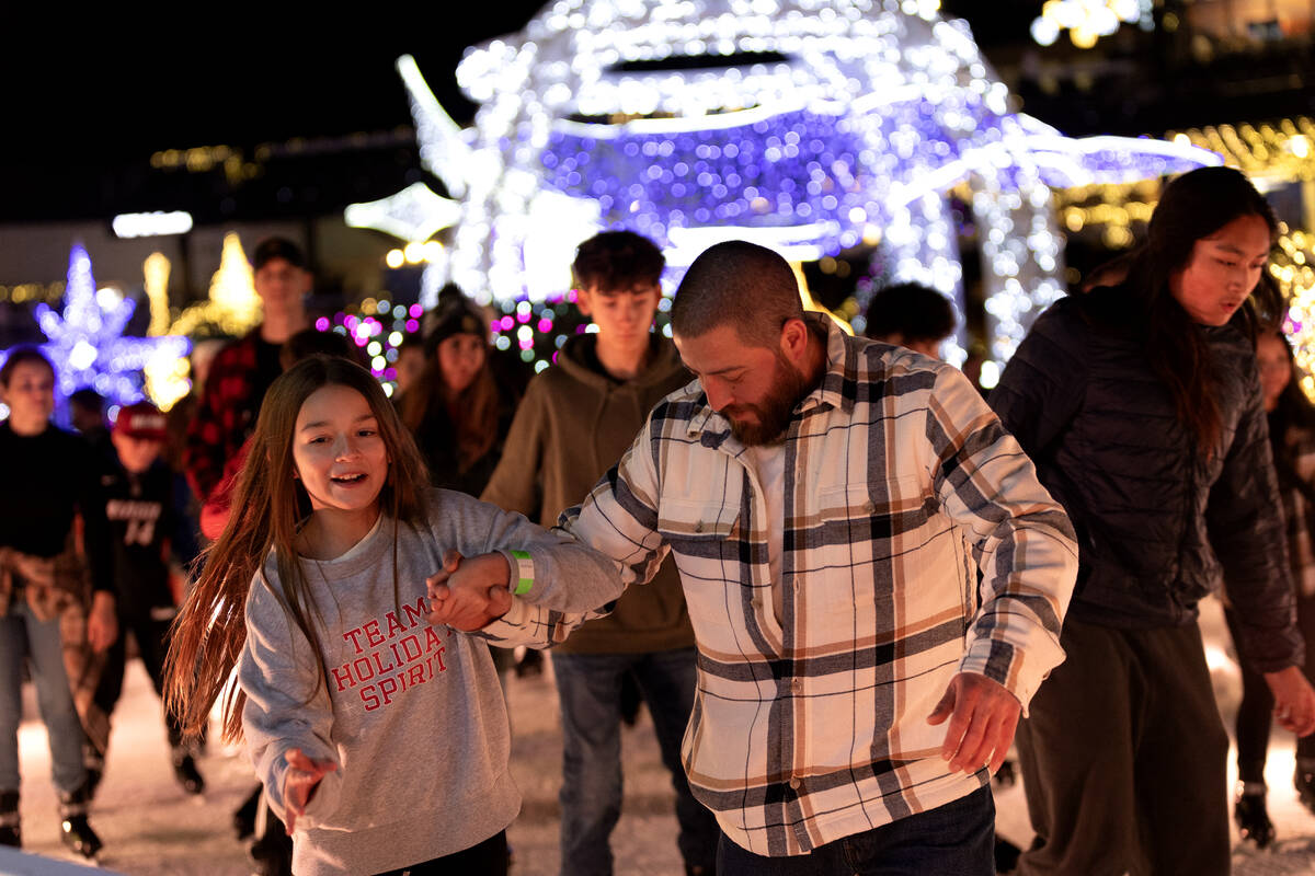 Ice skaters slip and slide along the course during the Enchant light show at the Las Vegas Ball ...