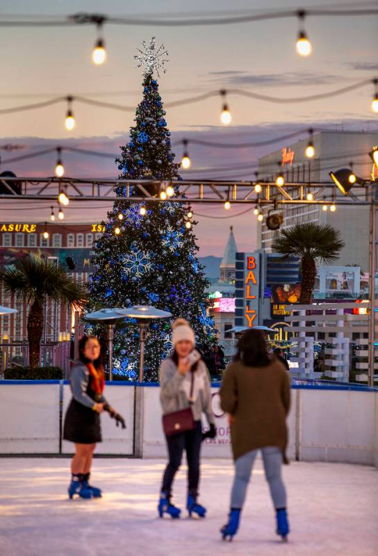 A giant Christmas tree is a visual backdrop at the ice rink at The Cosmopolitan of Las Vegas on ...