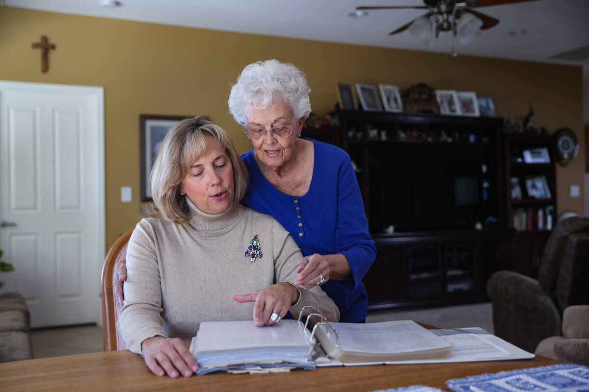 Sharon Willis, left, looks through a cookbook documenting decades of Christmas cookie club reci ...