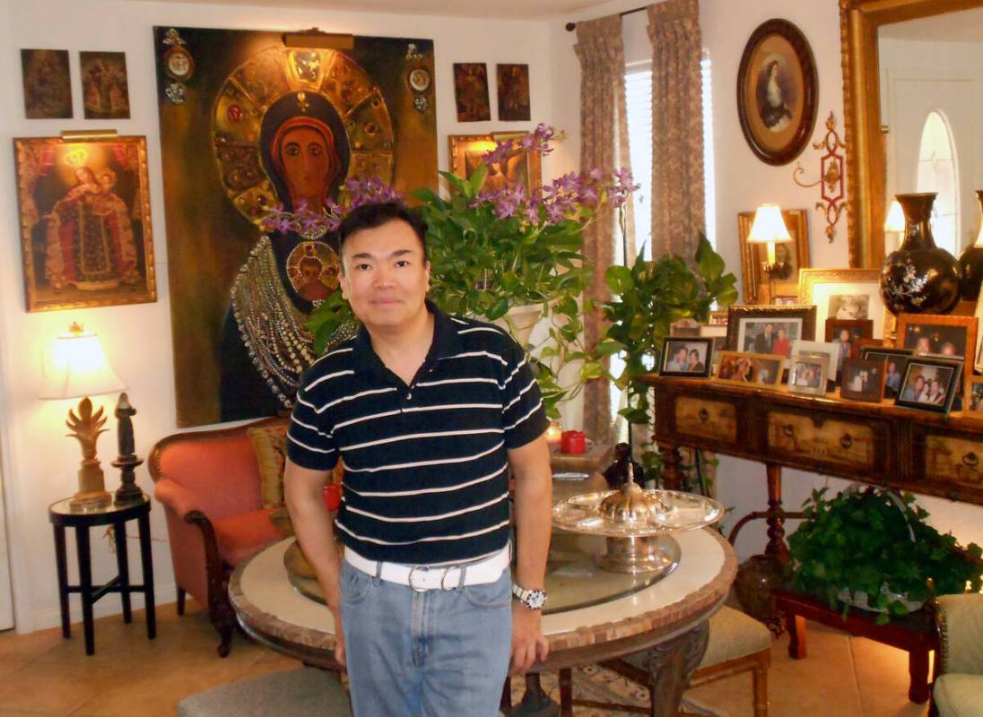 Fashion designer David Tupaz stands in the art-packed entryway of his southwest Las Vegas home. ...