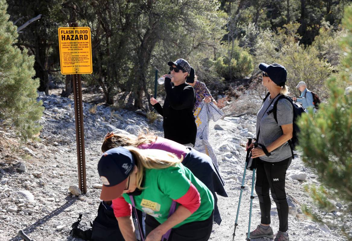 Members of the Westside Newcomers social club take a hydration and “shedding layers&#x20 ...