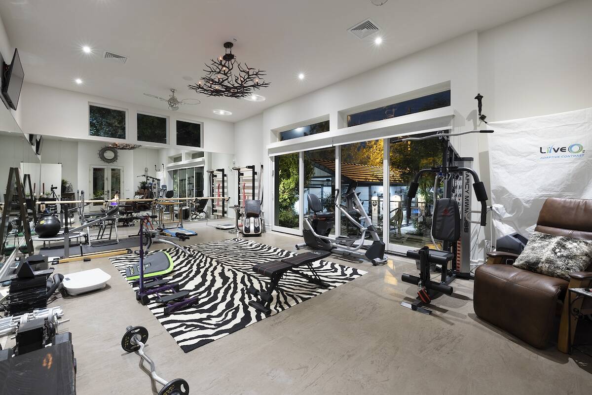 The separate building next to the pool offers a fully equipped gym that can double as a dance s ...