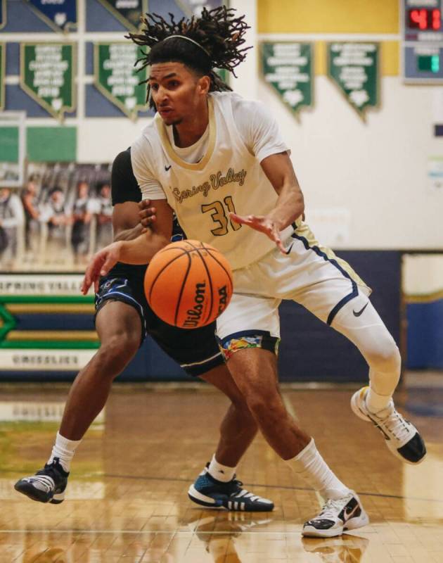 Spring Valley point guard Alijah Adem (31) struggles to keep the ball during a game against Des ...