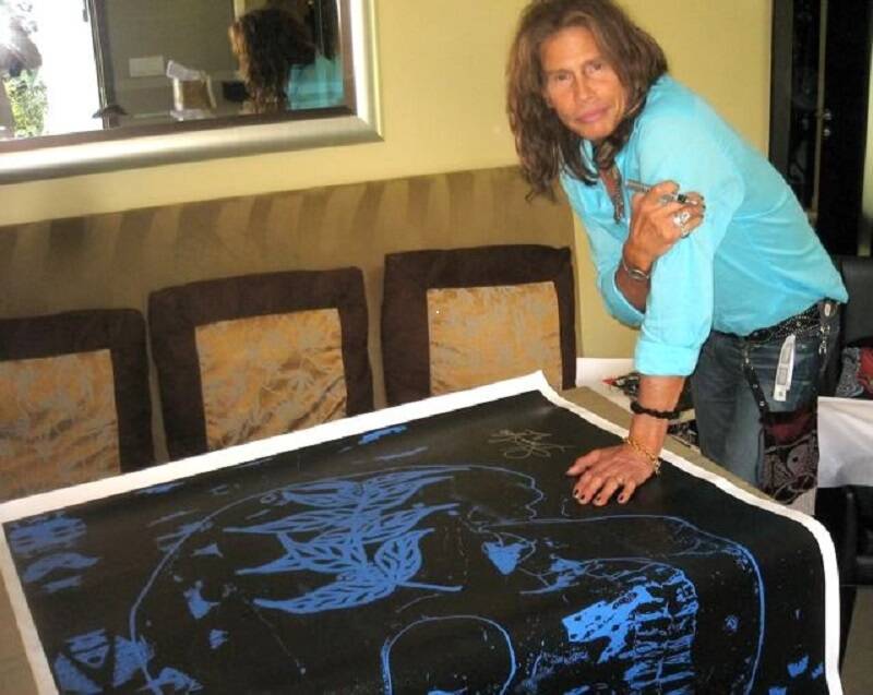 Aerosmith front man Steven Tyler is shown with his Blue Skull limited edition on canvas signed ...