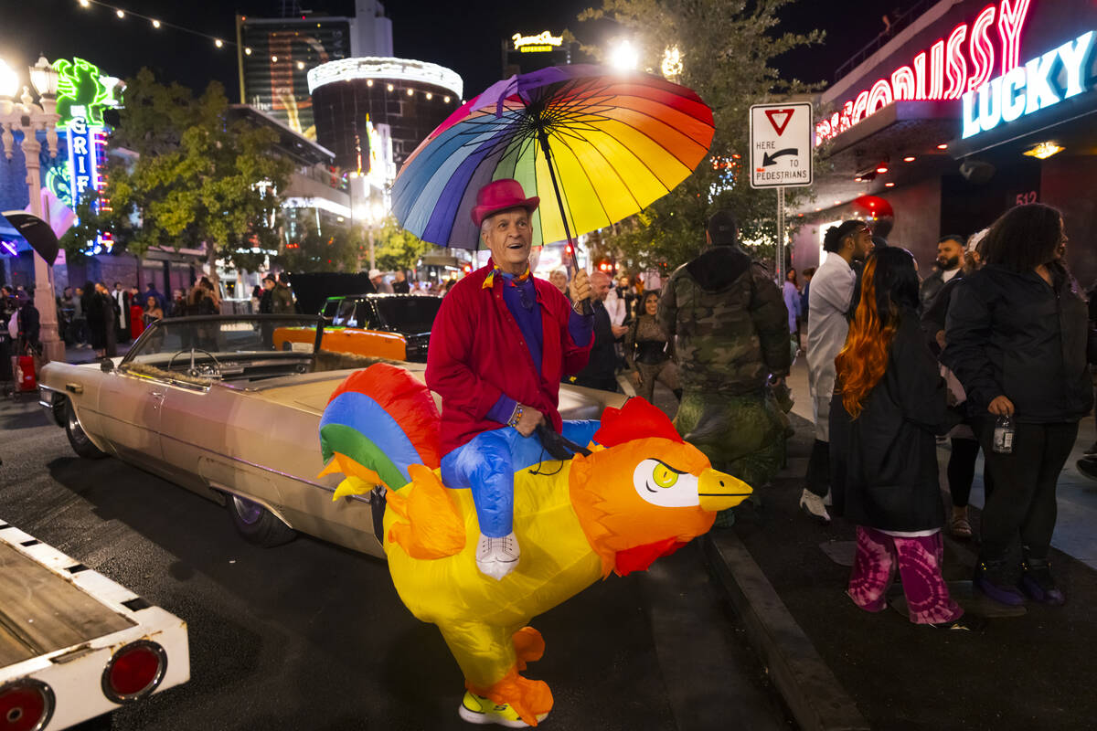 Erick Walck of Las Vegas walks along Fremont Street during Halloween night on Thursday, Oct. 31 ...