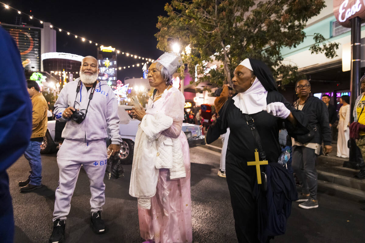 People walk and dance along Fremont Street during Halloween night on Thursday, Oct. 31, 2024, i ...