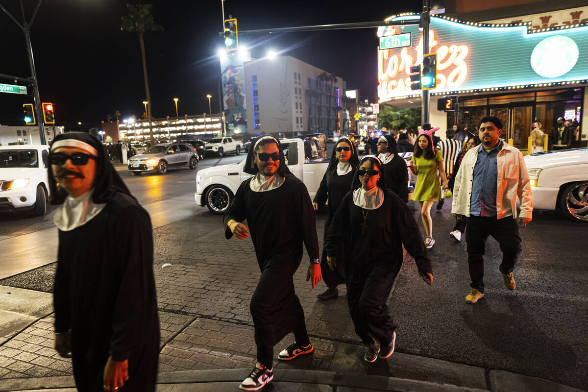 A group of nuns crosses the street outside of the El Cortez during Halloween night on Friday, N ...