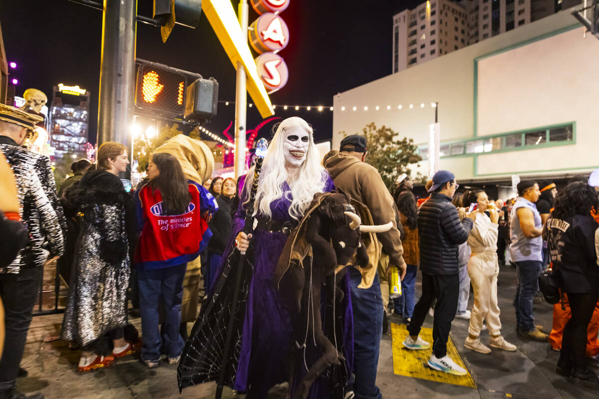 People walk along Fremont Street during Halloween night on Thursday, Oct. 31, 2024, in Las Vega ...