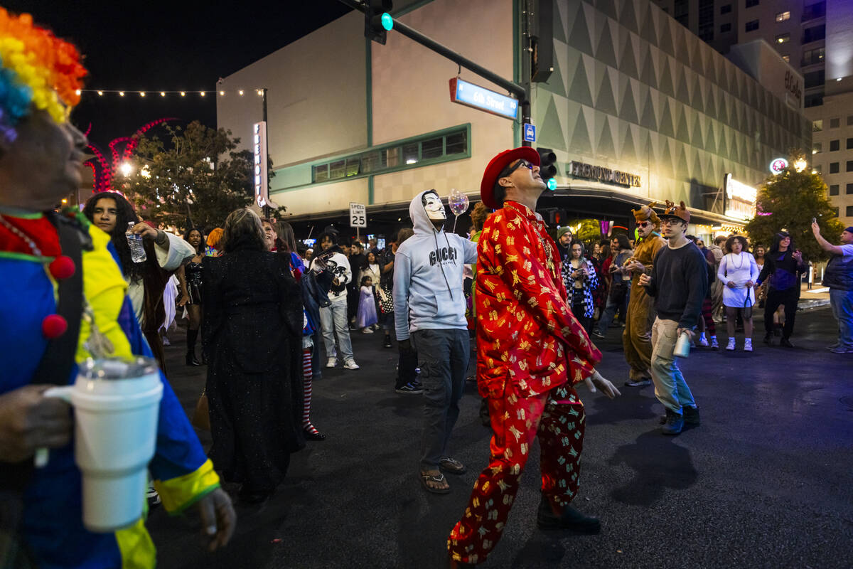 People dance Fremont Street during Halloween night on Thursday, Oct. 31, 2024, in Las Vegas. (C ...