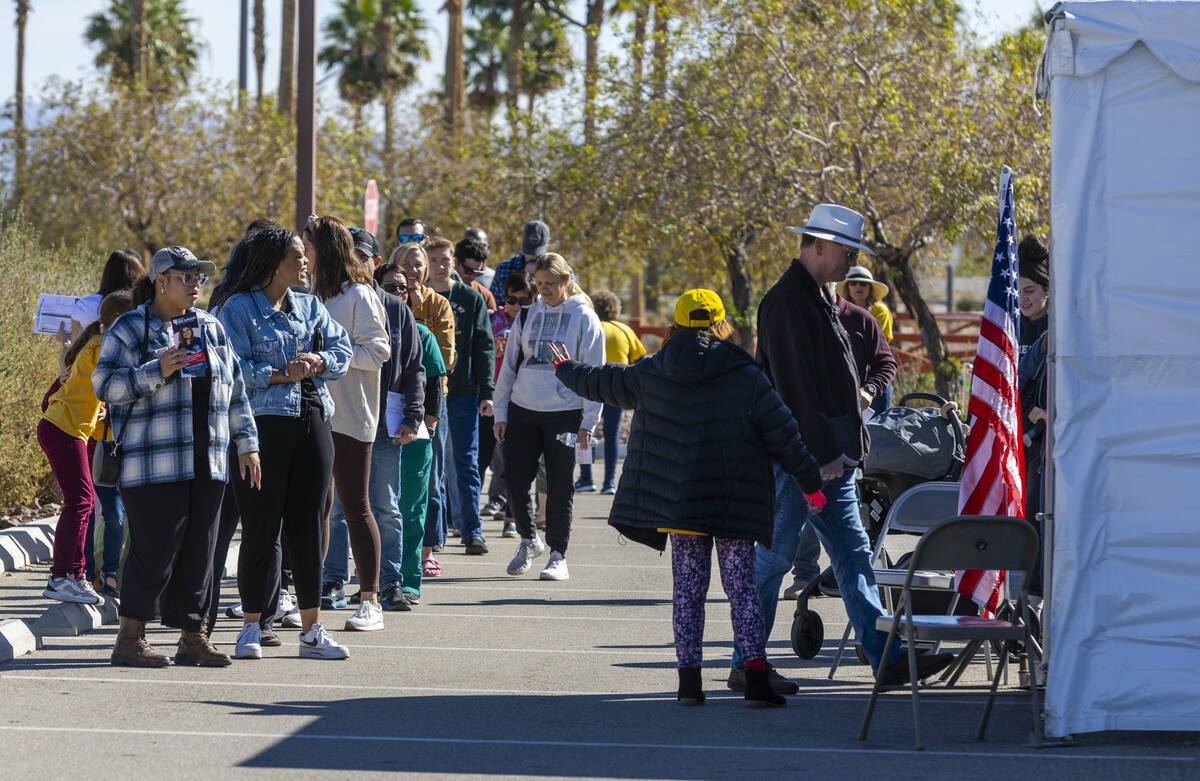 Voters wait in line to cast their ballots on the final day of early voting at the Thunderbird F ...