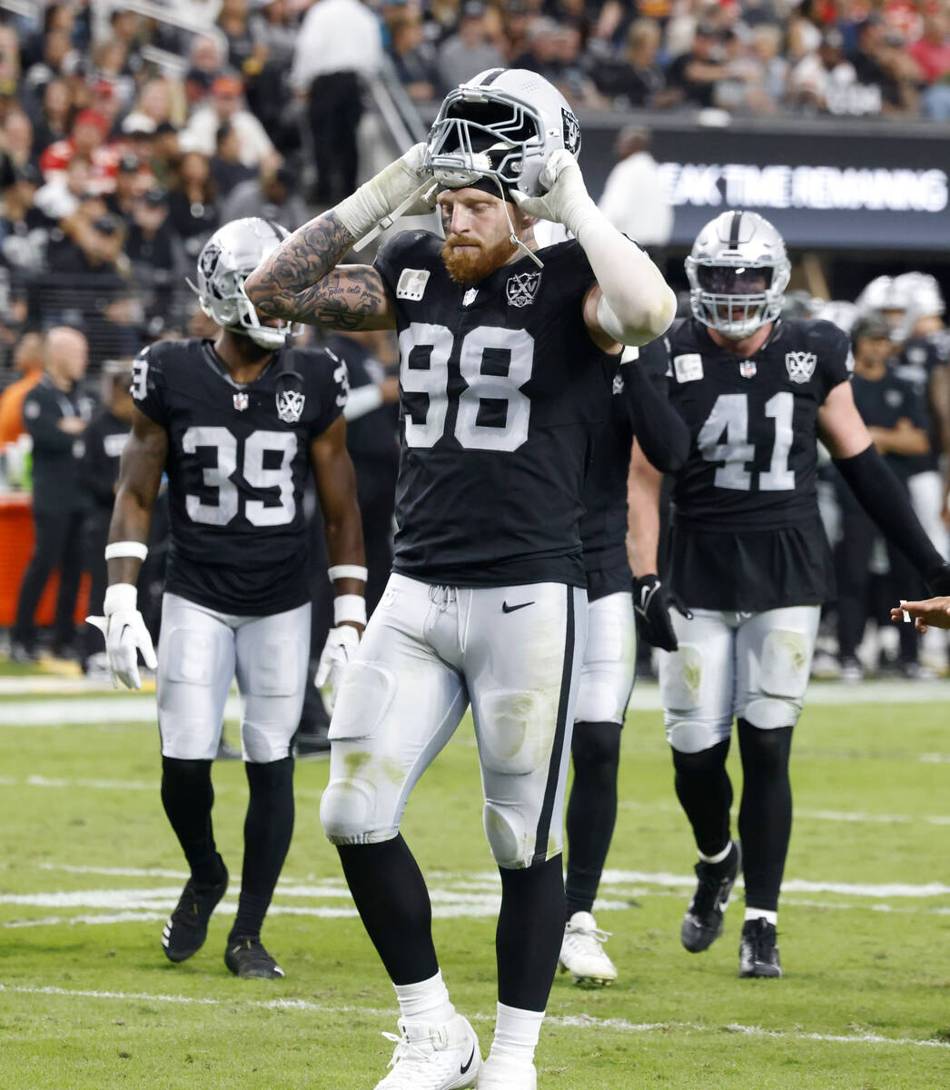 Raiders defensive end Maxx Crosby (98) puts his helmet on as he takes the field during the seco ...