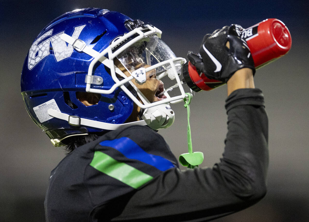 Green Valley senior Theodore Edquilang hydrates during the 5A Division II Southern League footb ...