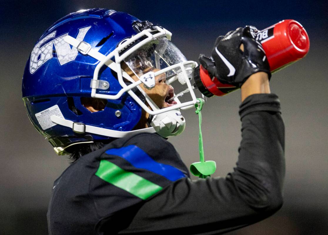 Green Valley senior Theodore Edquilang hydrates during the 5A Division II Southern League footb ...