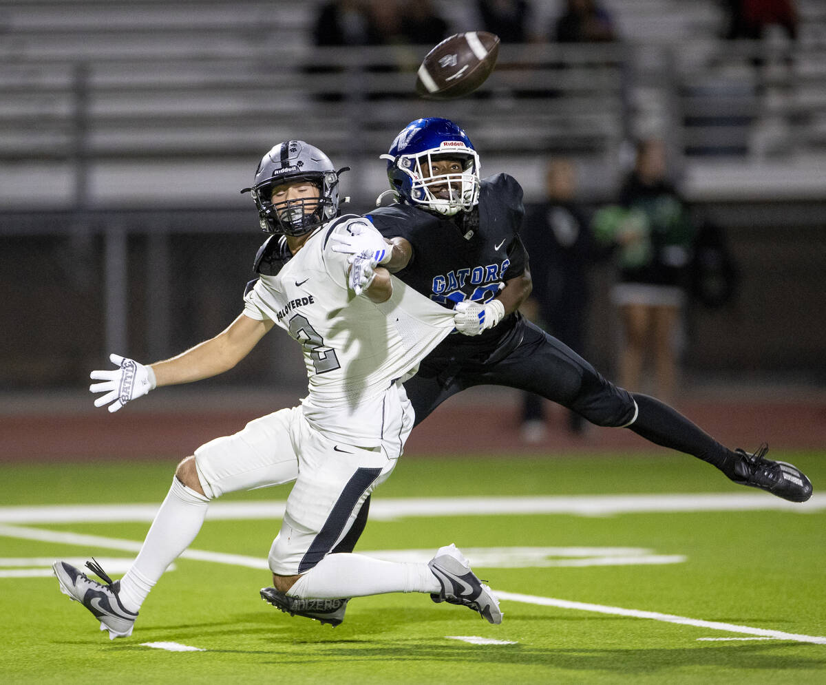 Green Valley’s Elyjah Cobwell, right, tugs on the jersey of Palo Verde senior Slade Knoc ...