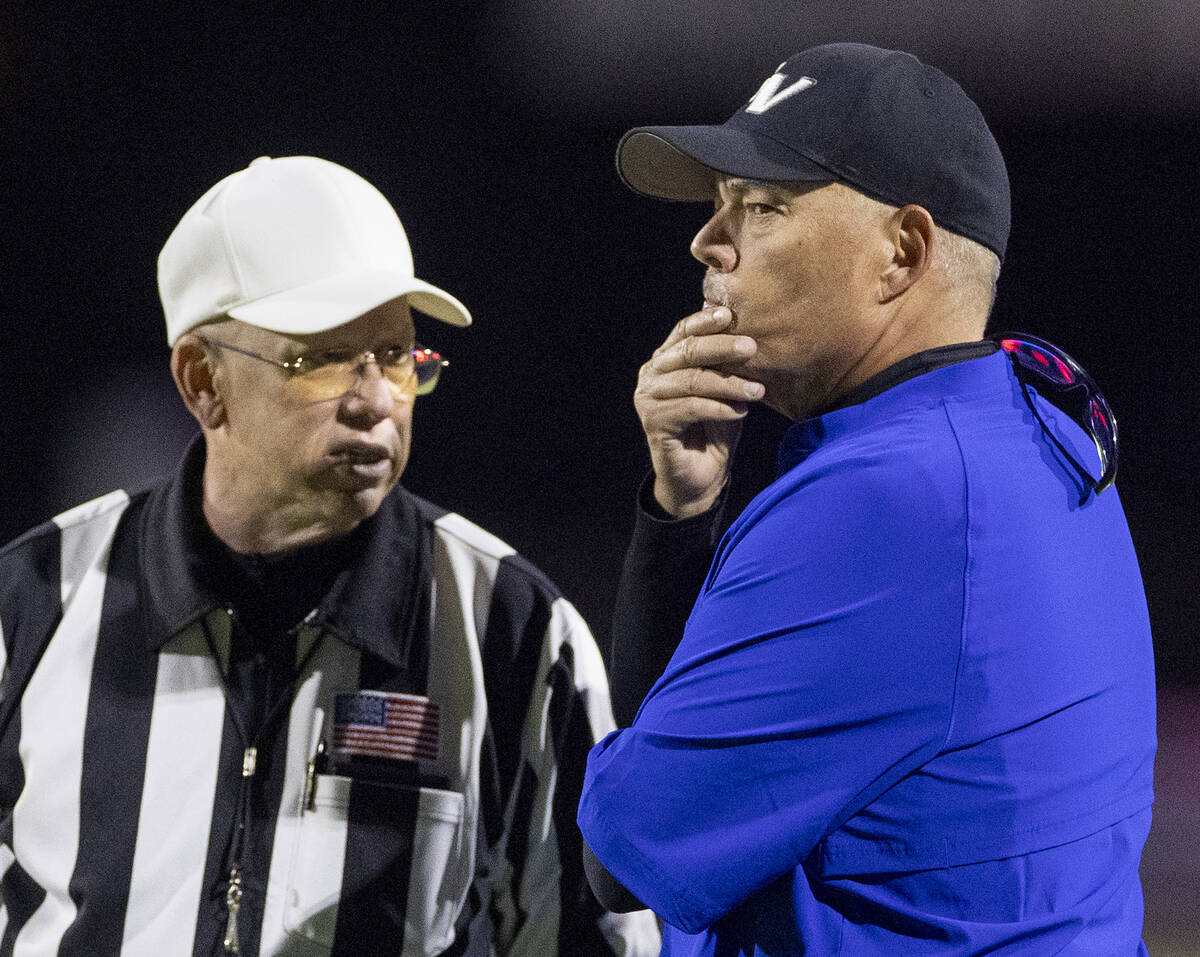 Green Valley Head Coach Bill Powell, right, talks with the referees after a penalty is called o ...