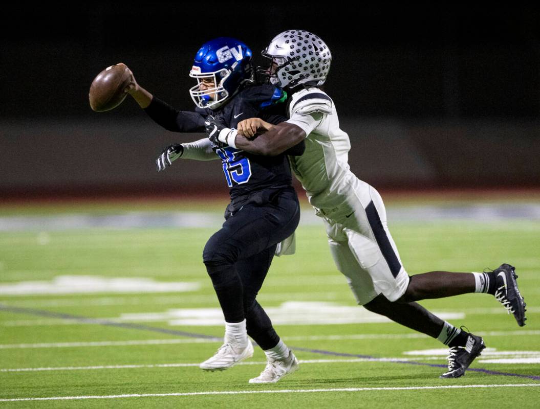 Green Valley quarterback Michael Lewis (15) is tackled by Palo Verde senior De'anthony Thompson ...