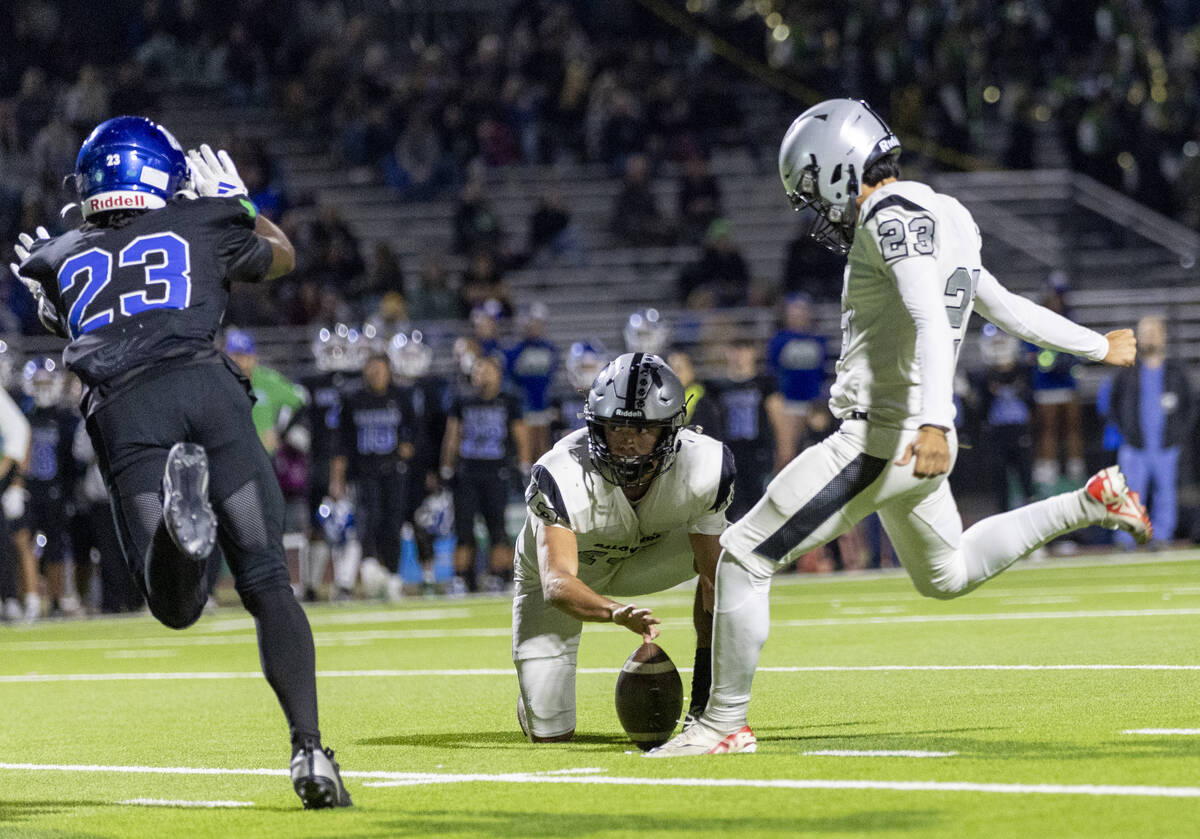 Green Valley’s Elyjah Cobwell (23) dives in front of Palo Verde kicker Noah Cerna (23), ...