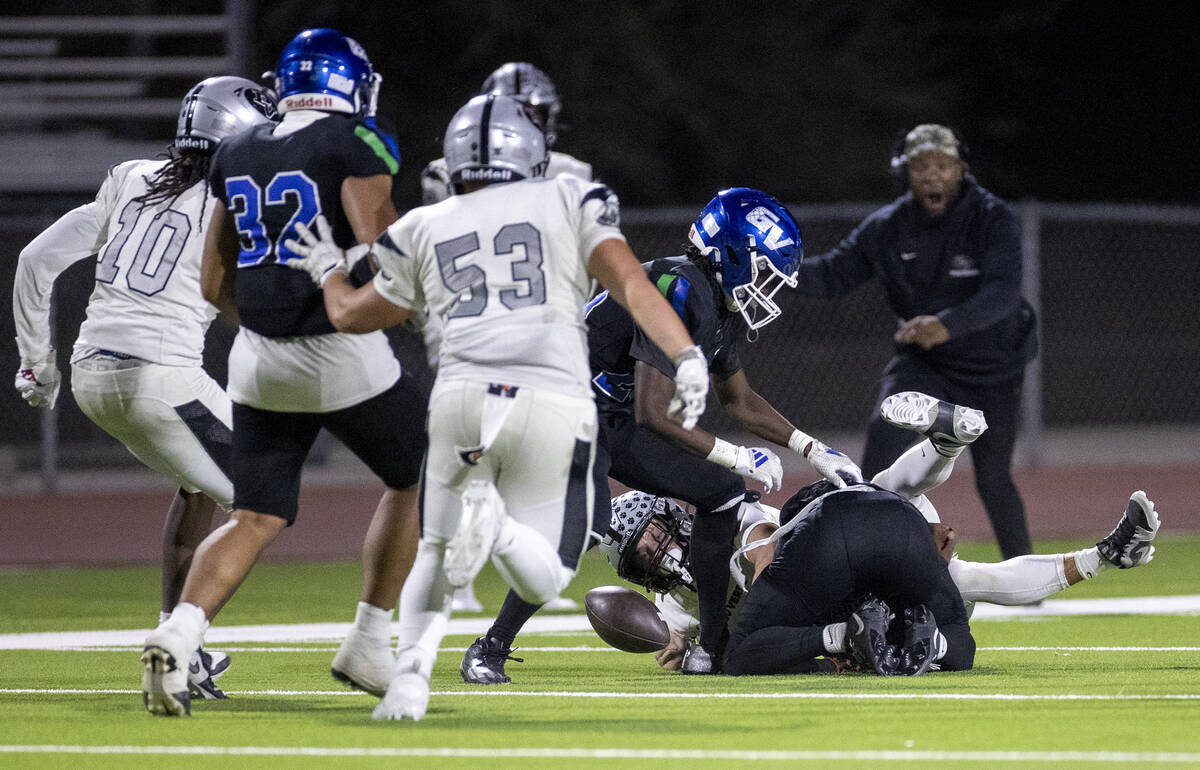 Palo Verde and Green Valley players dive for a fumble caused by a Green Valley player dropping ...