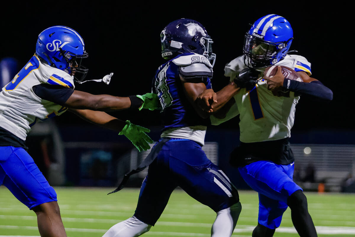 Sierra Vista’s Adonis Vaughn (1) is tackled by Shadow Ridge defensive back Trevin Young ...