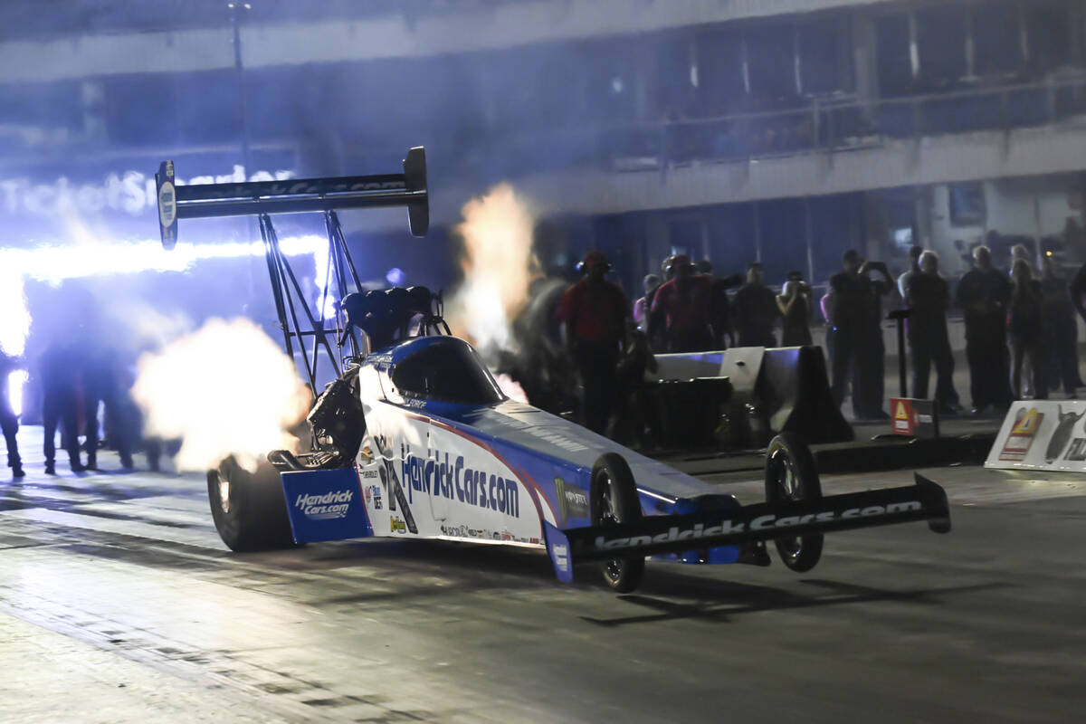 In this photo provided by the NHRA, Top Fuel's Brittany Force sits atop the field at the Texas ...