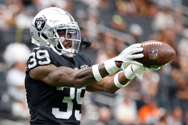 Raiders cornerback Nate Hobbs (39) catches the ball as he warms up before an NFL game against ...