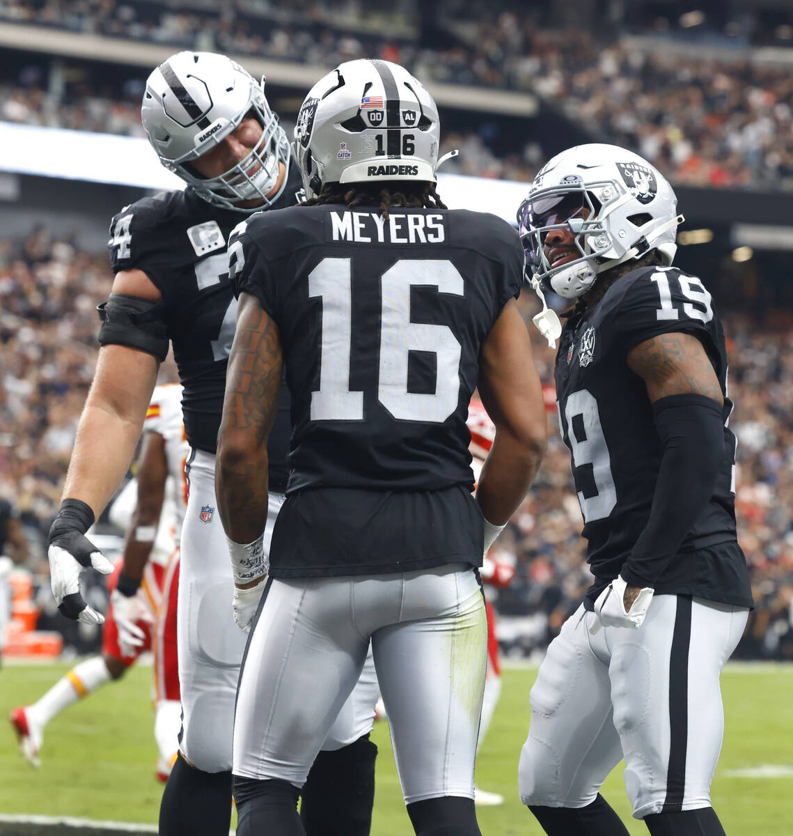 Raiders wide receiver Jakobi Meyers (16) celebrates his touchdown with offensive tackle Kolton ...