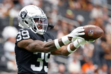 Raiders cornerback Nate Hobbs (39) catches the ball as he warms up before an NFL game against ...