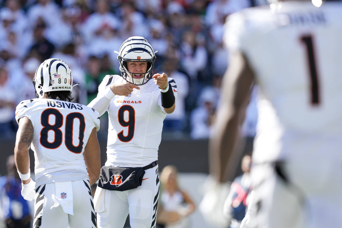 Cincinnati Bengals quarterback Joe Burrow (9) gestures in the direction of wide receiver Ja'Mar ...