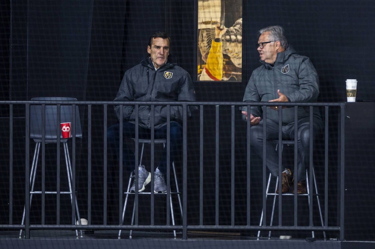 Golden Knights President of Hockey Operations George McPhee listens to general manager Kelly Mc ...