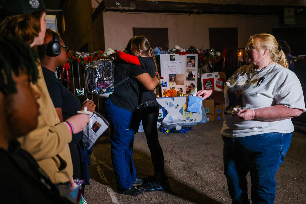 Mellisa Ready, second from right, hugs Neysha Velasquez during a vigil for Ready’s son, 17-ye ...