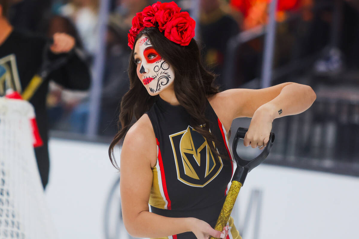 A member of the Knights Guard shovels ice during an NHL hockey game between the Golden Knights ...