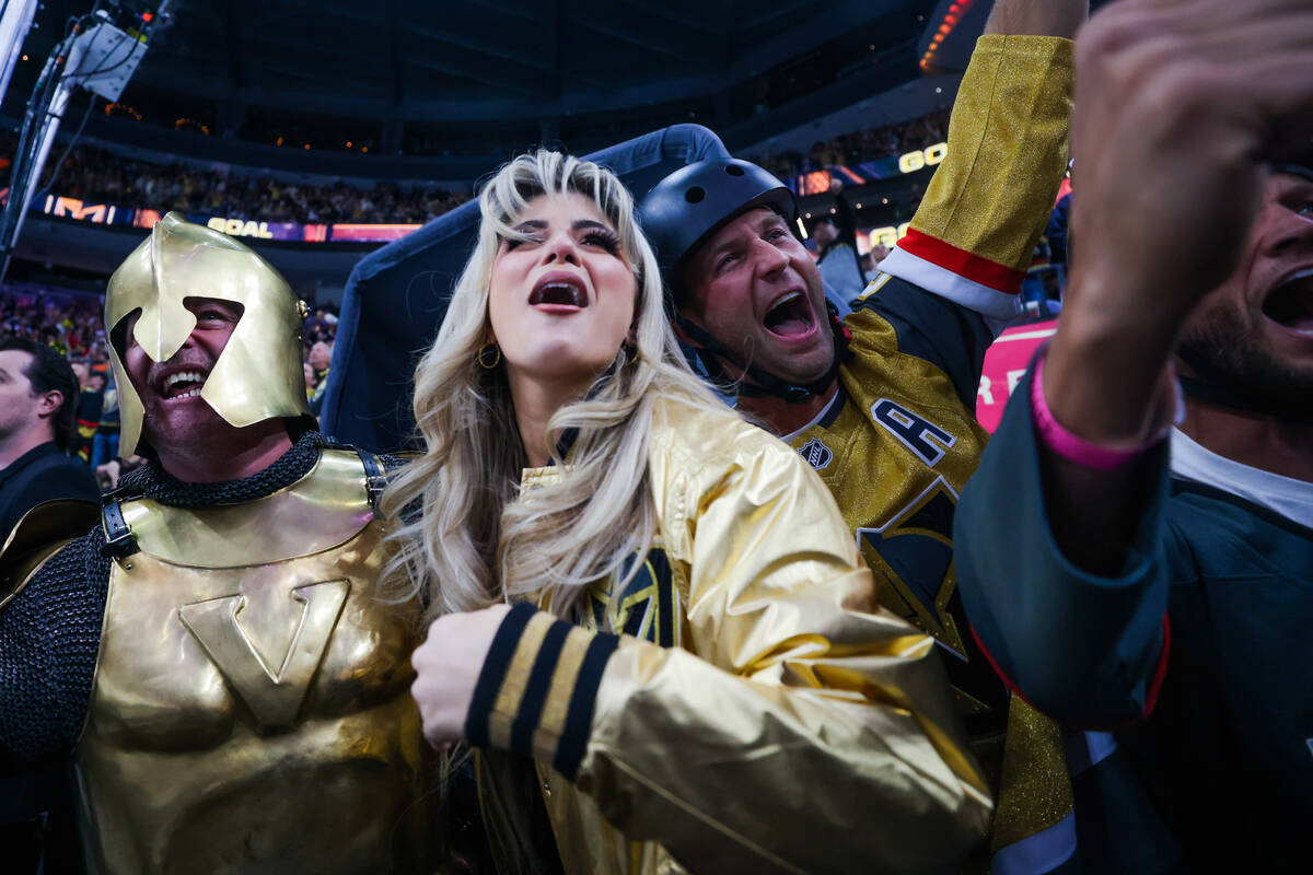 The Golden Knight, left, cheers with in-arena host Katie Marie Jones, middle, and Golden Knight ...