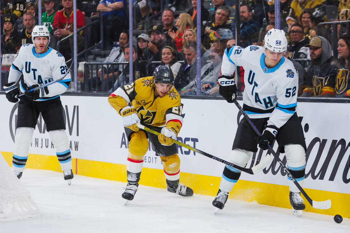 Golden Knights center Brett Howden (21) closes in on the puck as Utah Hockey Club defenseman Vl ...