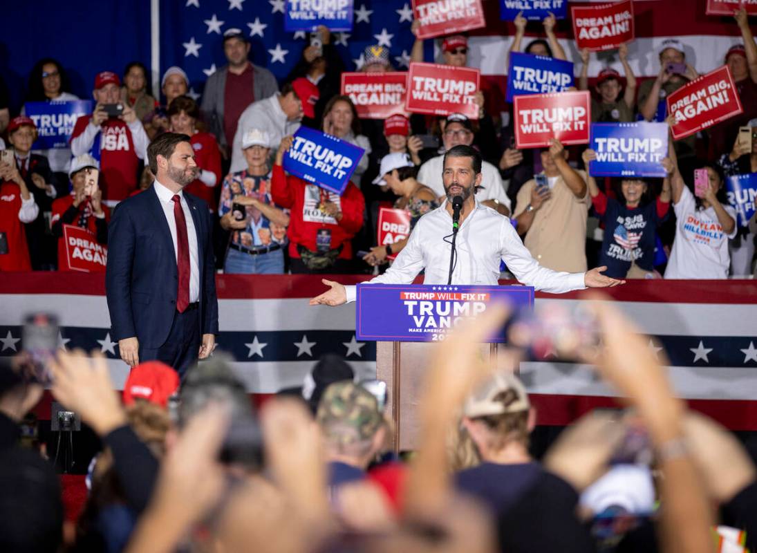 Republican vice presidential nominee Sen. JD Vance, R-Ohio, left, watches Donald Trump Jr., rig ...