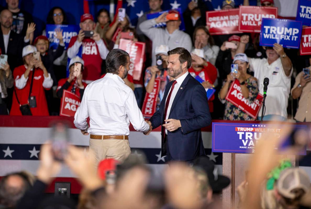 Republican vice presidential nominee Sen. JD Vance, R-Ohio, right, welcomes Donald Trump Jr., l ...