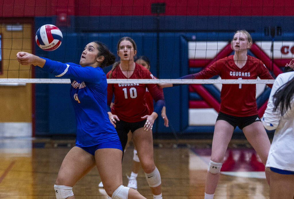 Bishop Gorman's Trinity Thompson (9) digs out a shot as Coronado's Rachel Schwartz (10) and Han ...