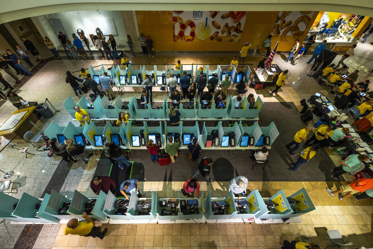 Voters finally get to the front of the line to cast their ballots in a polling spot in the Gall ...