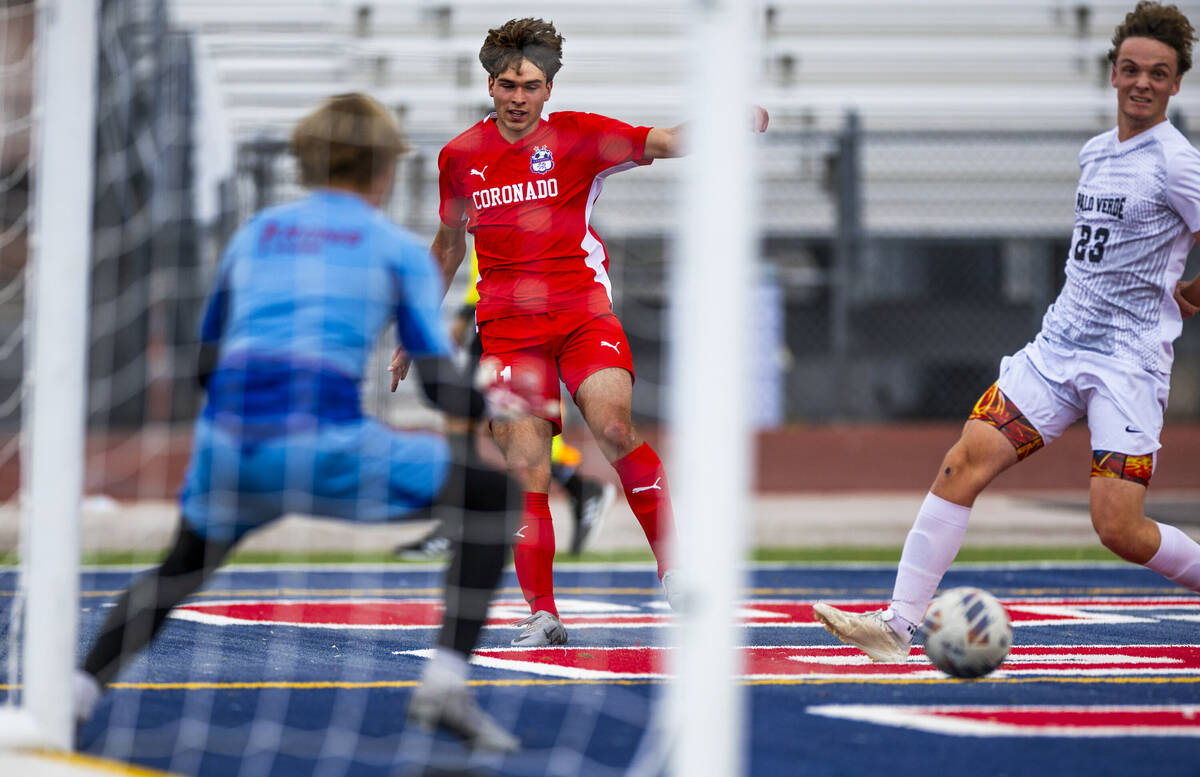 Coronado striker Gavin Flickinger (11) sends a pass away from Palo Verde defender Ben Legrand ( ...