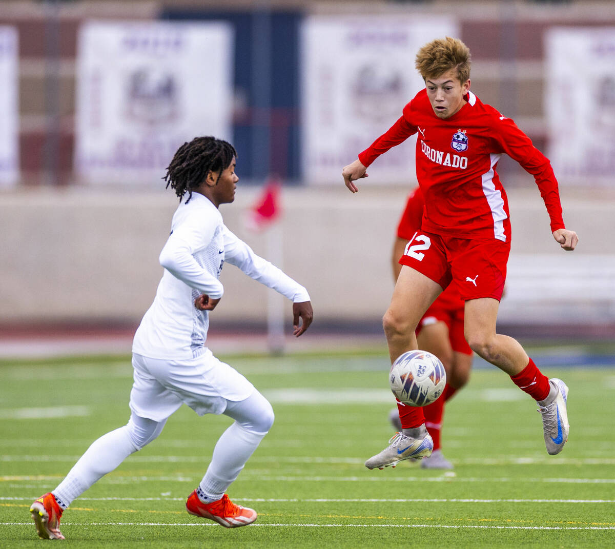 Coronado midfielder Liam Bringhurst (12) heads a ball down as Palo Verde halfback Shilo Stephen ...