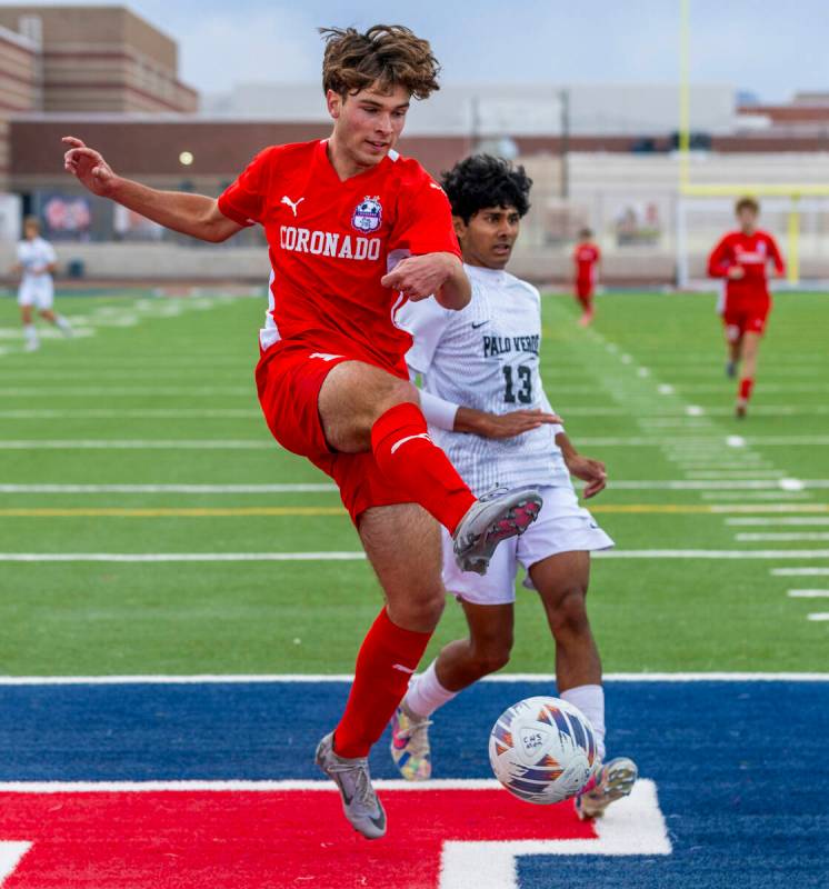 Coronado striker Gavin Flickinger (11) takes a shot at the goal with Palo Verde wing back Haydn ...