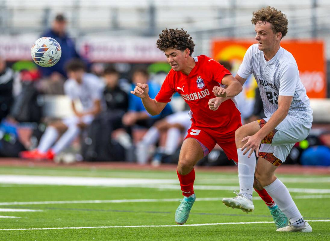 Coronado striker Dylan Flores (9) heads the ball away from Palo Verde defender Ben Legrand (23) ...