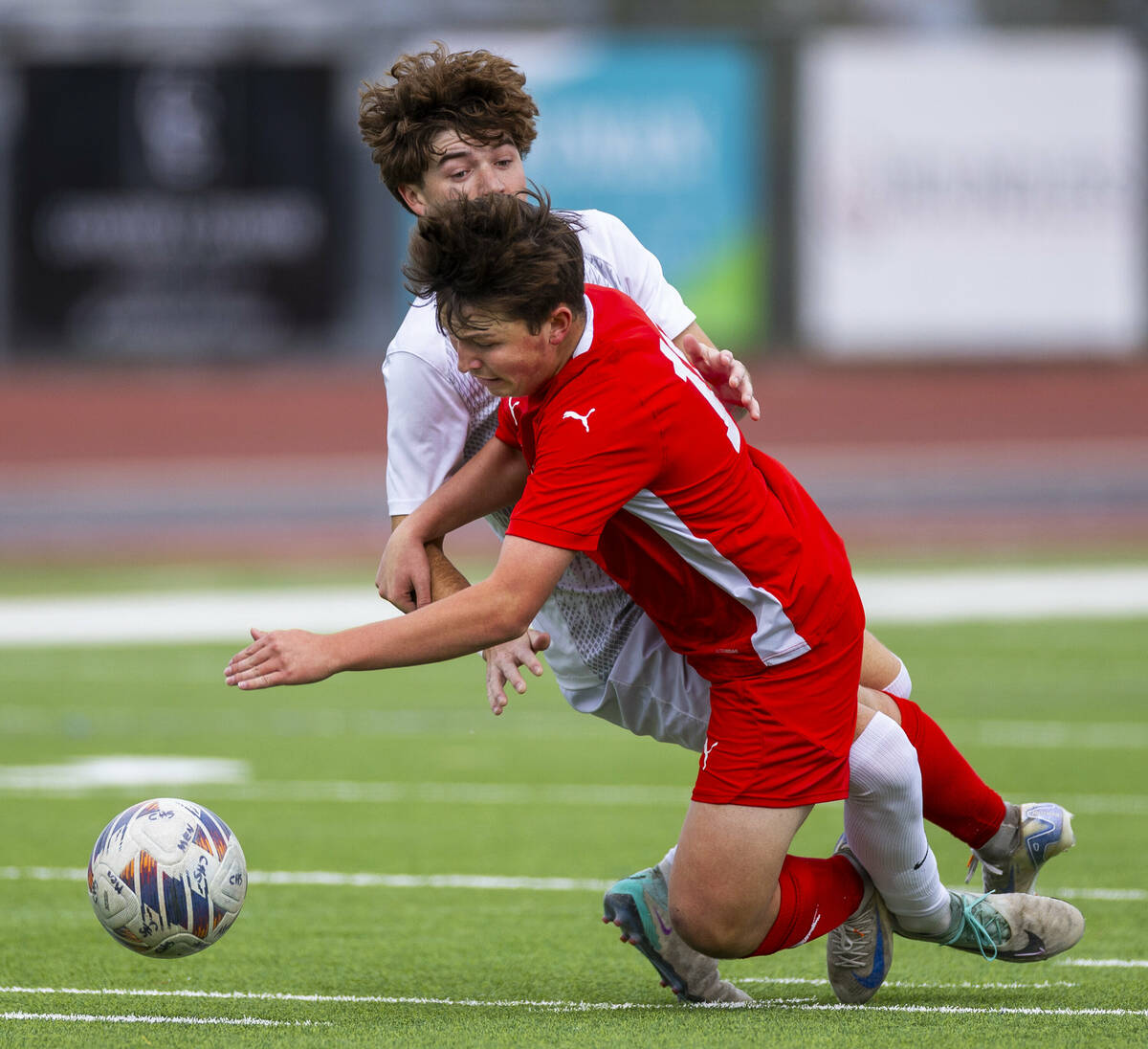 Coronado midfielder Aiden Sena (10) is tackled by Palo Verde defender Jaxon Law (2) during the ...