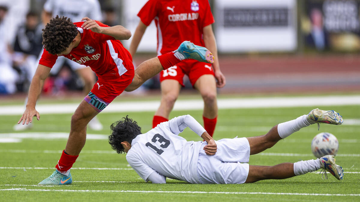 Palo Verde wing back Haydn Rodrigues (13) slides to steal the ball from Coronado striker Dylan ...