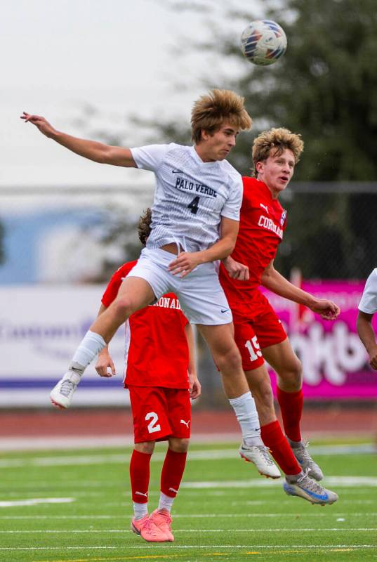 Palo Verde forward Luke Knecht (4) heads the ball away from Coronado defender Ben Aronow (15) ...