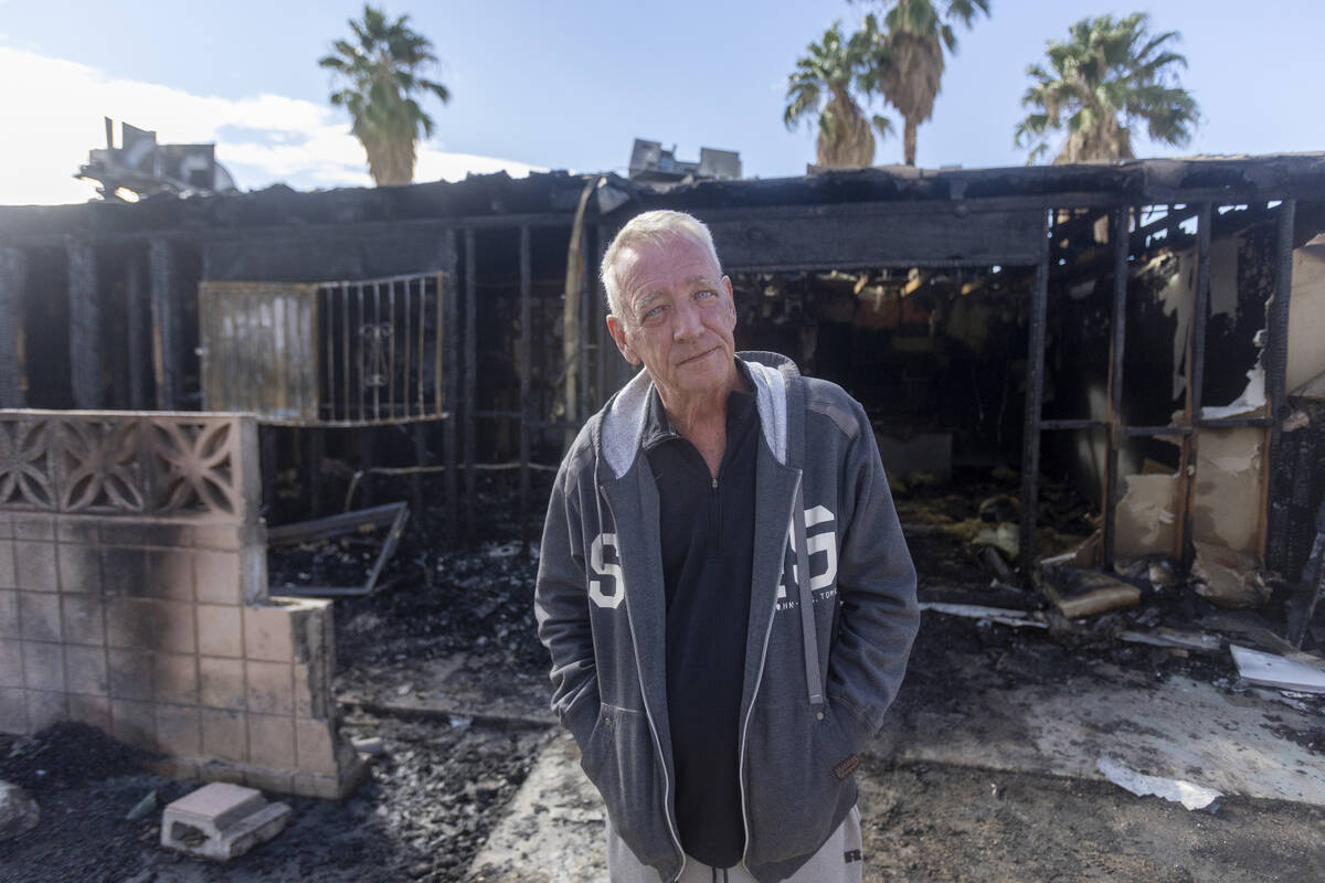 Paradise Spa homeowners association president Dennis Snapp stands outside an apartment that bur ...