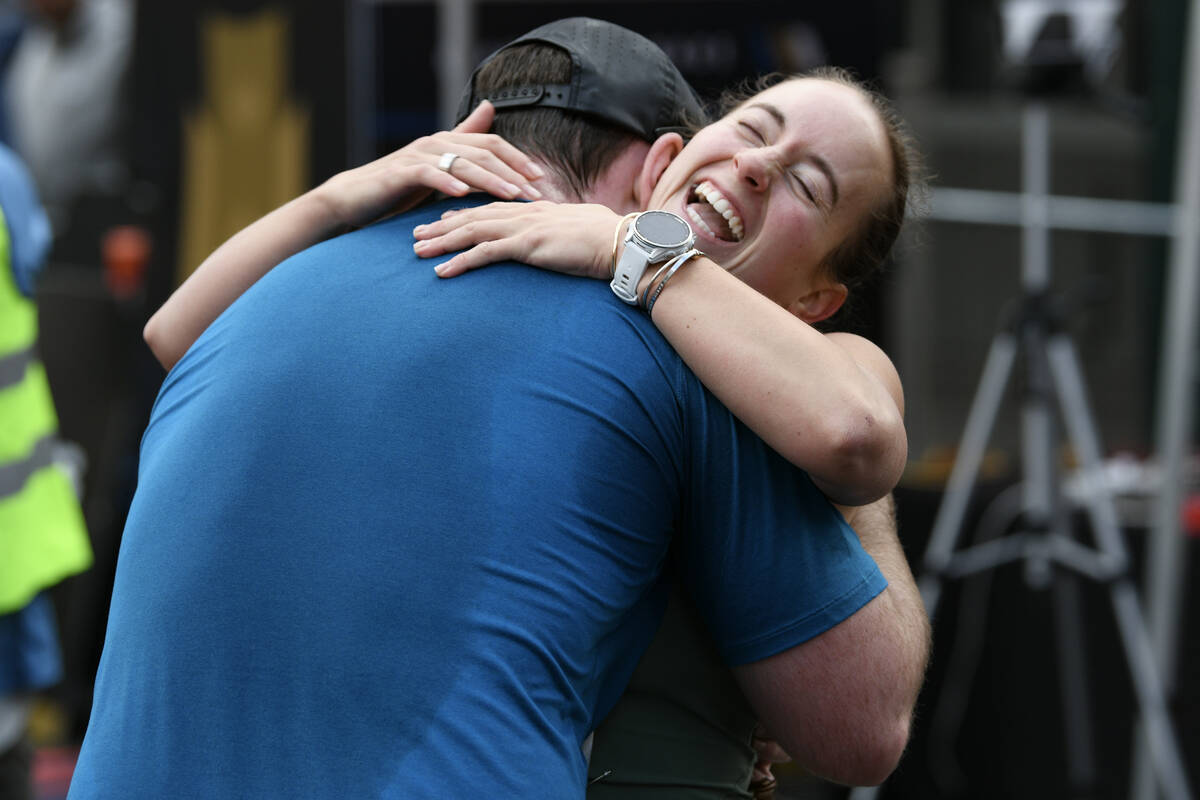 Victoria Berlandi hugs Travis Hanlon after finishing the Las Vegas Marathon Sunday, Nov. 3, 202 ...