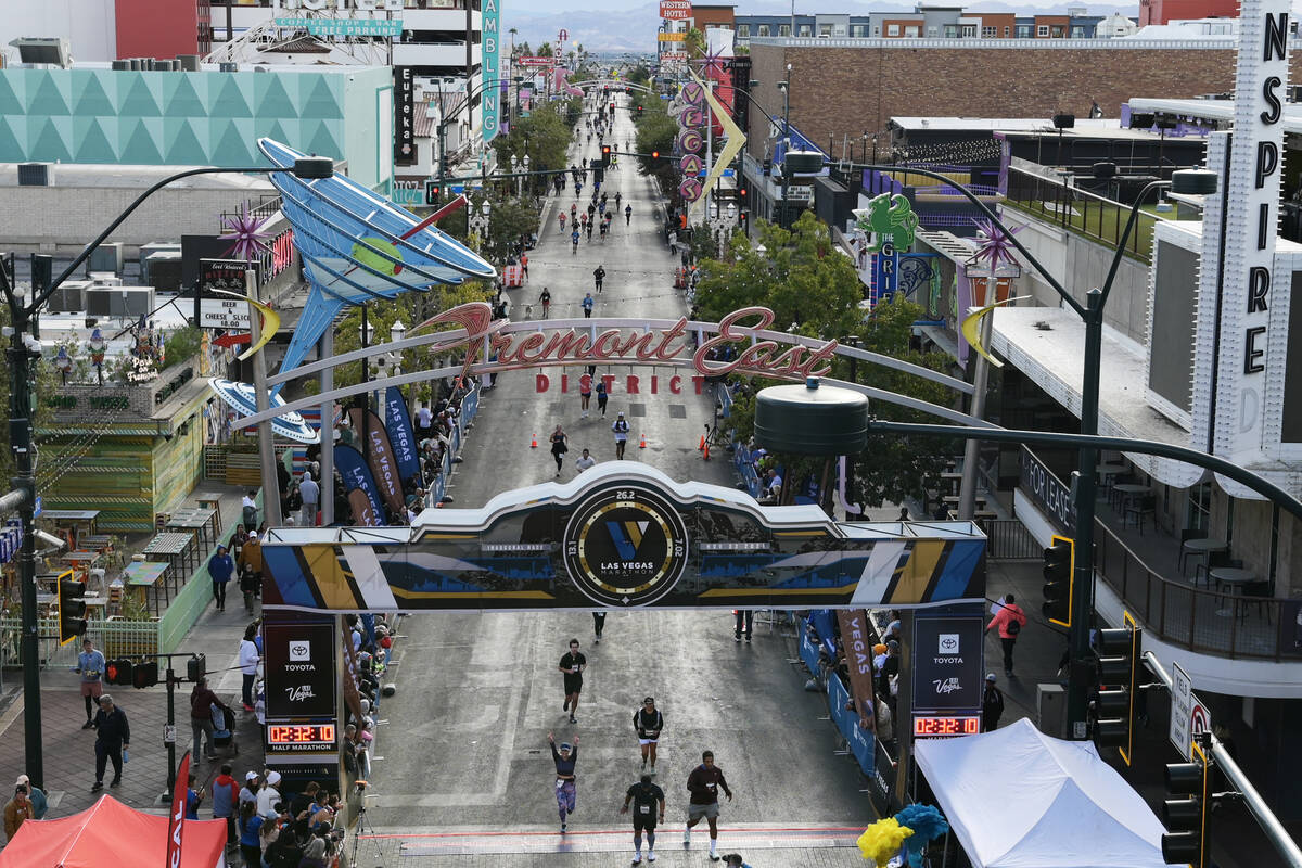 Participants head towards the finish line on Fremont Street during the Las Vegas Marathon Sunda ...