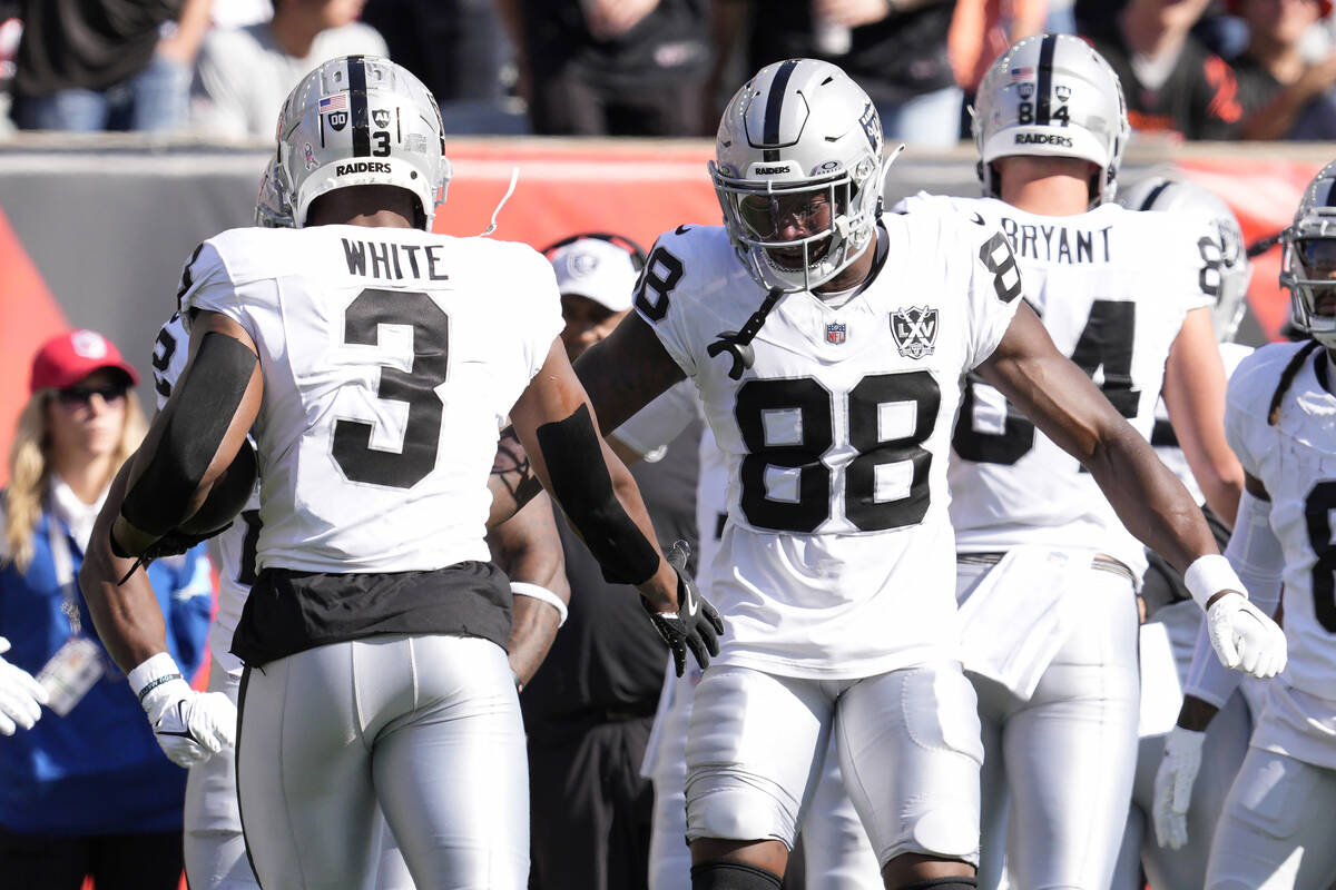 Las Vegas Raiders running back Zamir White (3) is congratulated by tight end Justin Shorter (88 ...