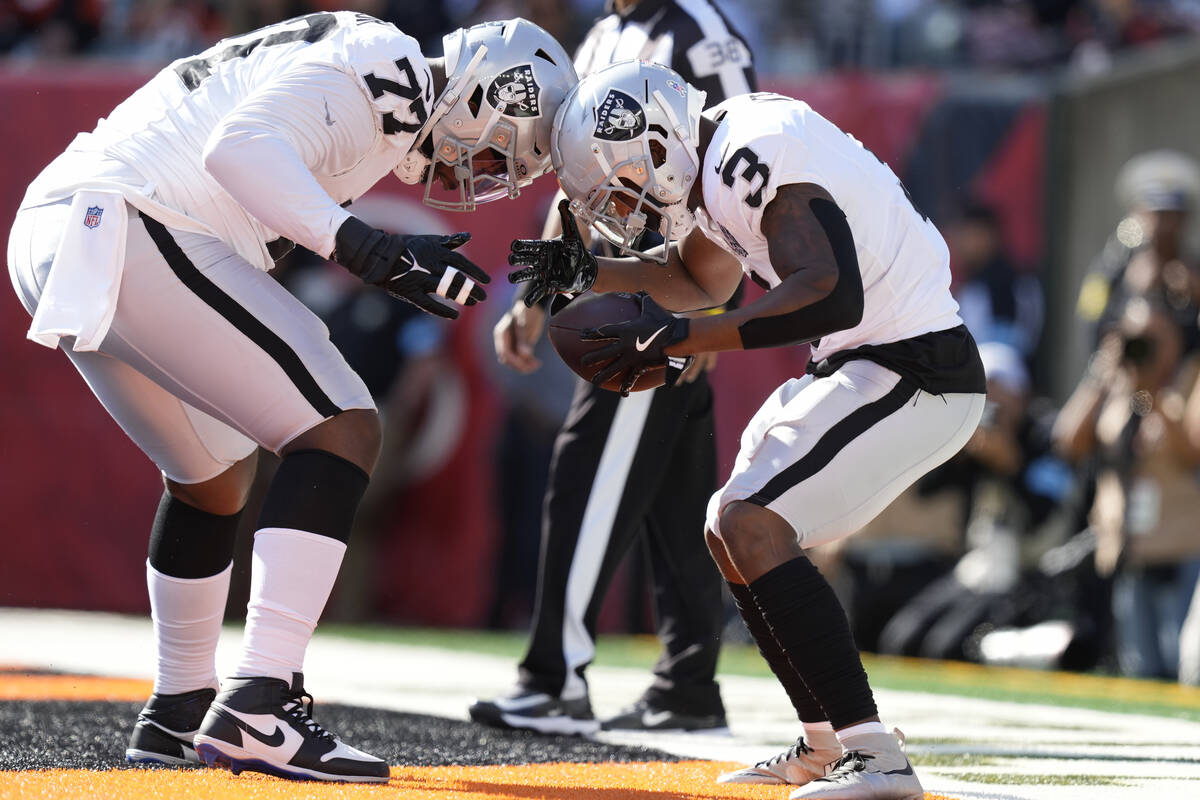 Las Vegas Raiders running back Zamir White (3) celebrates after scoring a touchdown with offens ...