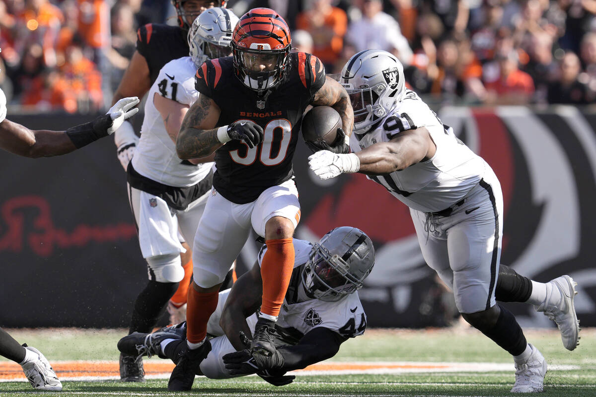 Cincinnati Bengals running back Chase Brown (30) runs against Las Vegas Raiders linebacker Robe ...